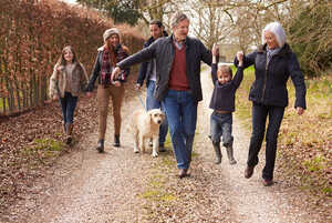 Three generations of a family taking a walk in the countryside