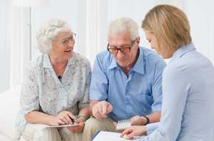 Older couple discussing terms with a mortage adviser
