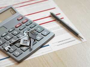 Mortgage application form with house keys, calculator and pen