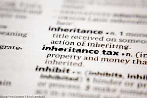 Close-up view of the phrase 'inheritance tax' in a dictionary