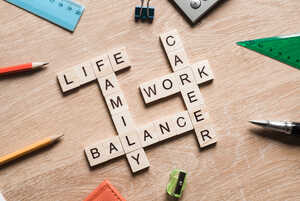 Scrabble-style letter tiles showing the words life, work, balance, family and career